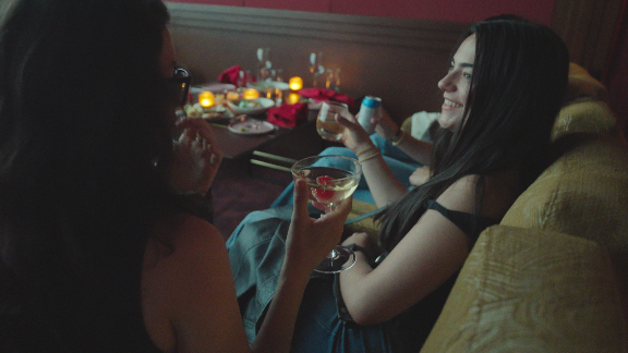 Guests relaxing with drinks in recliner seats during a private movie screening