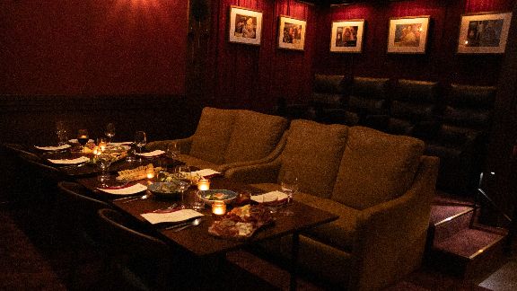 Private dining suite with plush seating, ambient lighting, and framed artwork