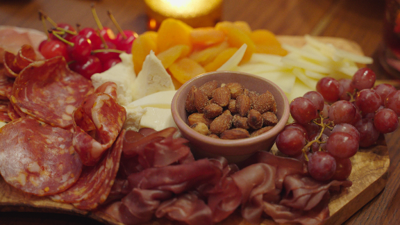 Charcuterie board with cured meats, grapes, almonds, and cheese at Metro Private Cinema
