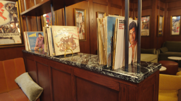 Lounge area with vintage vinyl records and album covers at Metro Private Cinema