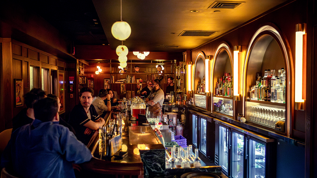 People drinking and enjoying martinis at Metro Private Cinema bar in Chelsea NYC