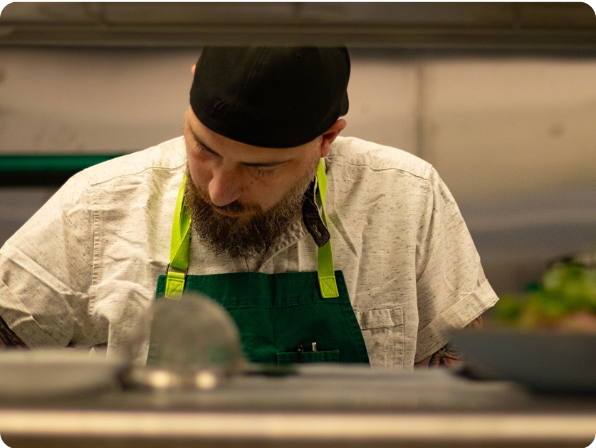 Chef Josh Guarneri preparing a meal in the Metro Private Cinema kitchen.