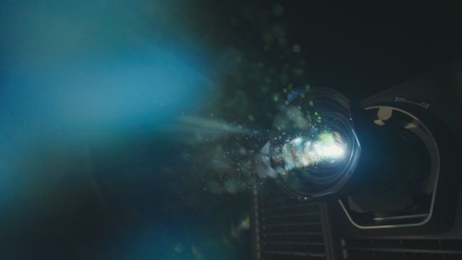 Vintage-style movie projector casting light during a private screening at Metro Private Cinema